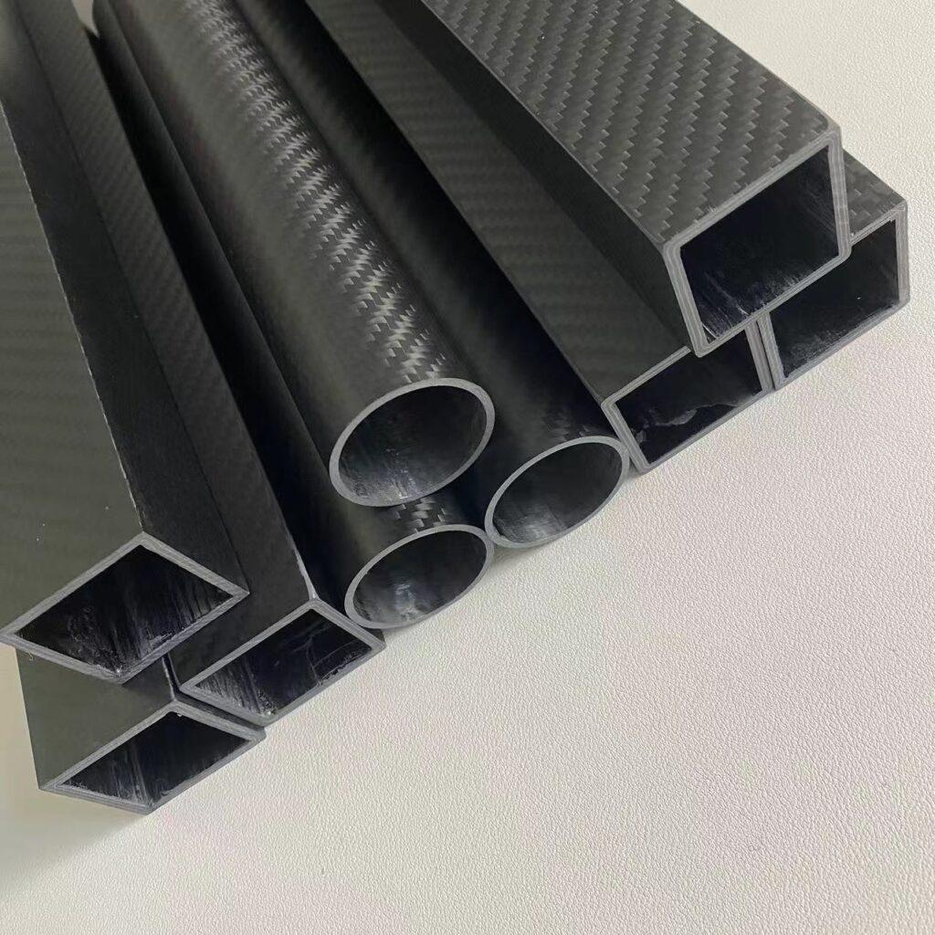 Round carbon fiber tube with a smooth matte finish, ideal for aerospace applications, showing high strength and lightweight properties.