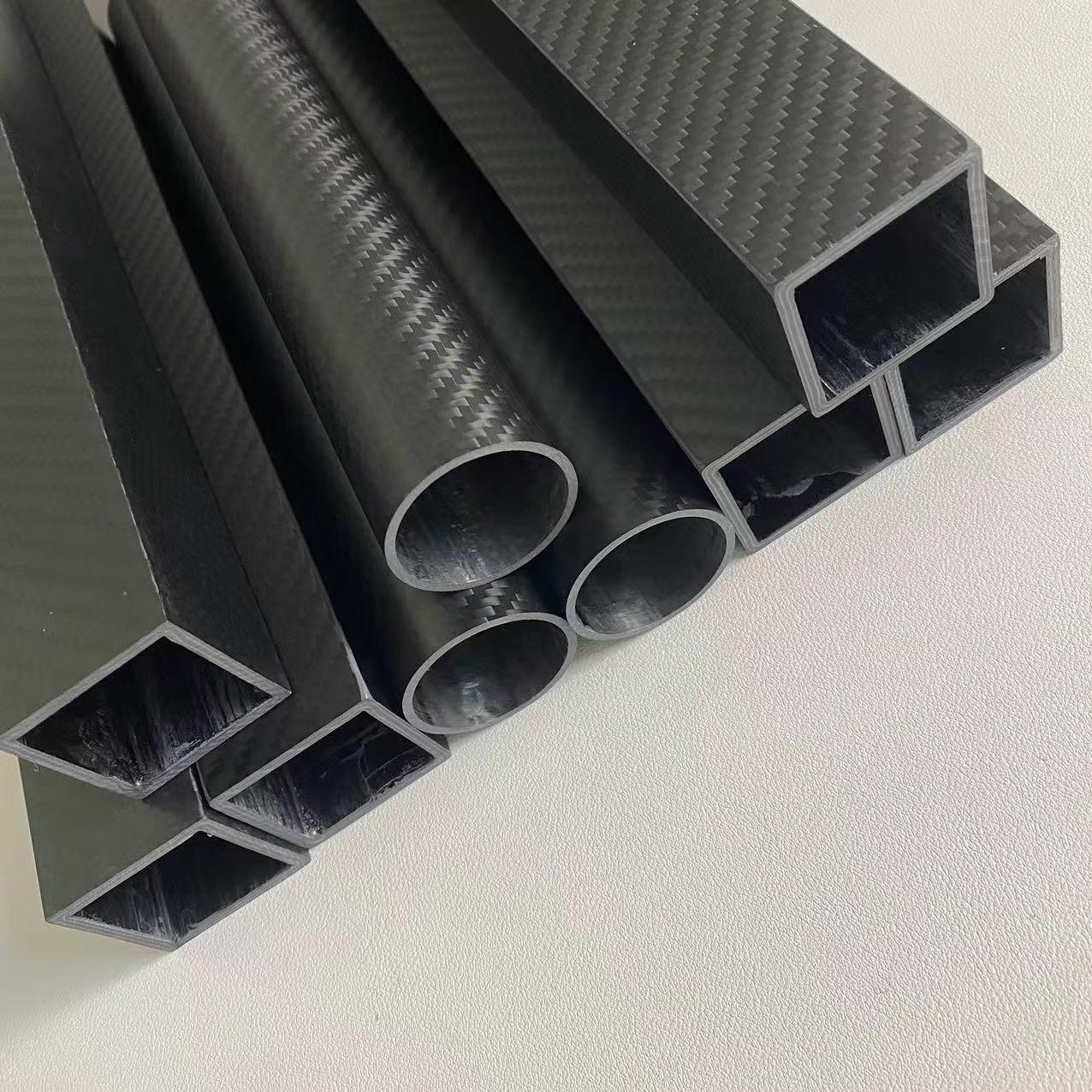 Round carbon fiber tube with a smooth matte finish, ideal for aerospace applications, showing high strength and lightweight properties.